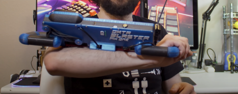 data blaster strapped to forearm of maker