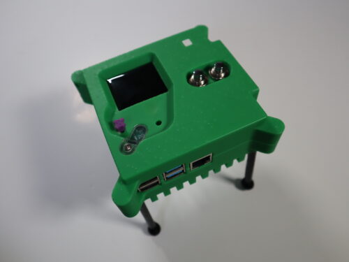 A 3D-printed Astro Pi unit replica with legs attached.