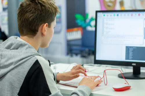 A young person codes at a Raspberry Pi computer.